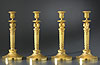 A superb set of four Empire gilt bronze candlesticks attributed to Claude Galle